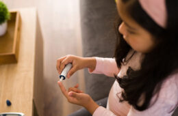 一个孩子用手指戳来检查自己的血糖水平