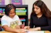 在克利夫兰霍夫附近的玛丽·b·马丁学校，CWRU二年级学生希万吉·南达和四年级学生克拉丽莎·托马斯一起参加课外识字活动。